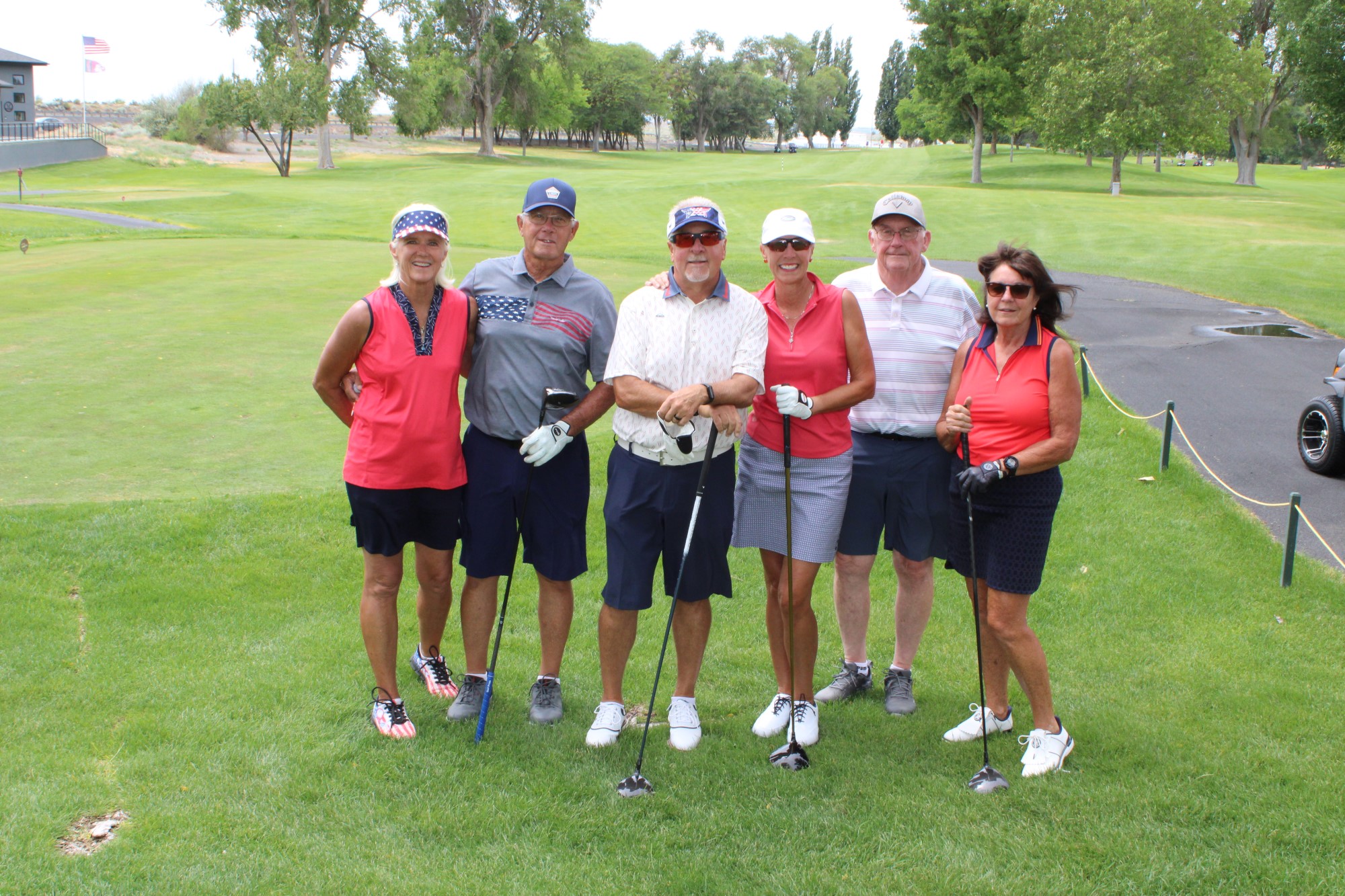 Golfers pose on the tee box at the Russ Hansen Memorial Scramble.