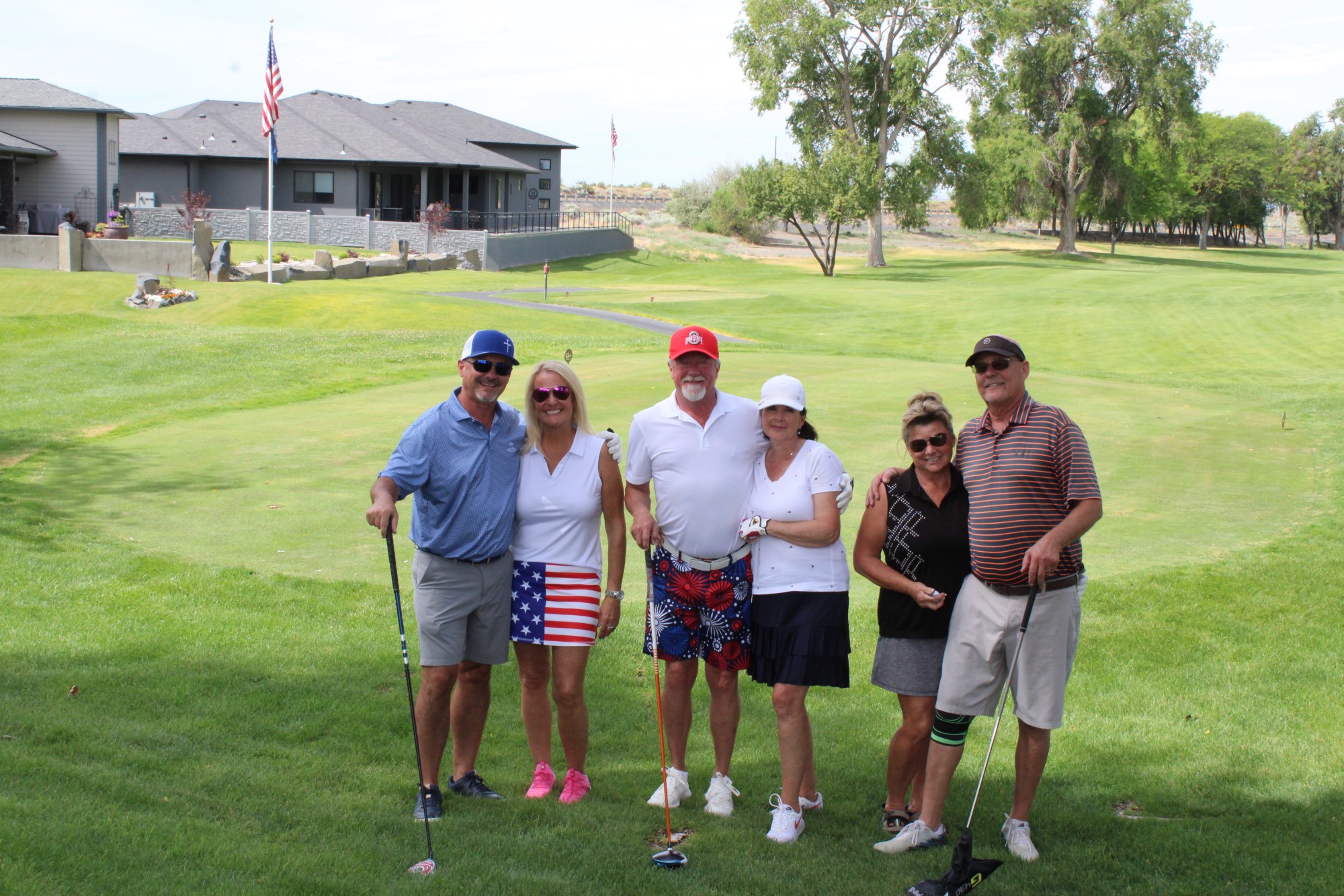Golfers pose on the green at the Russ Hansen Memorial Scramble.