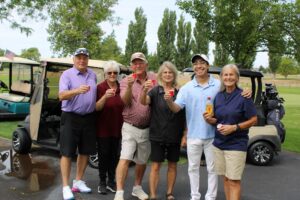 Golfers pose with shots of Fireball at the Russ Hansen Memorial Scramble.