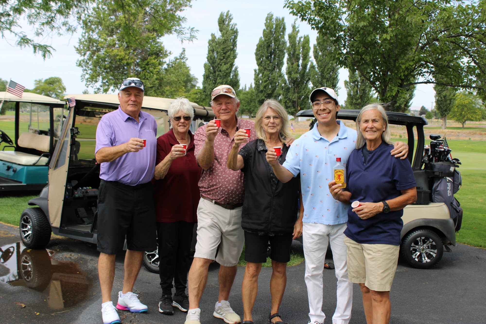 Golfers pose with shots of Fireball at the Russ Hansen Memorial Scramble.