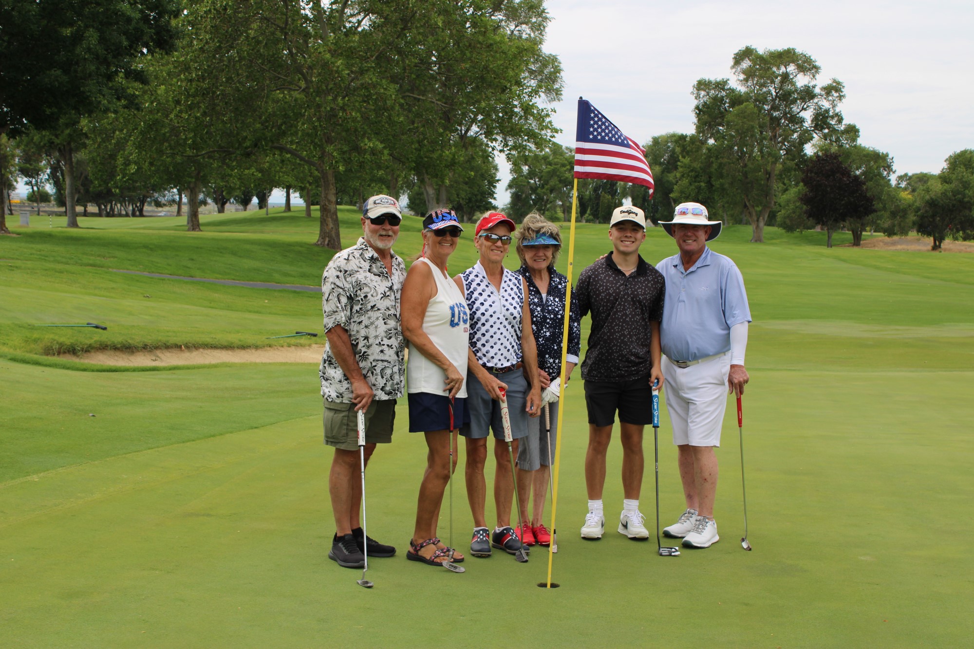 Golfers pose on the green at the Russ Hansen Memorial Scramble.