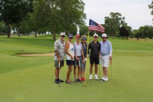 Golfers pose on the green at the Russ Hansen Memorial Scramble.