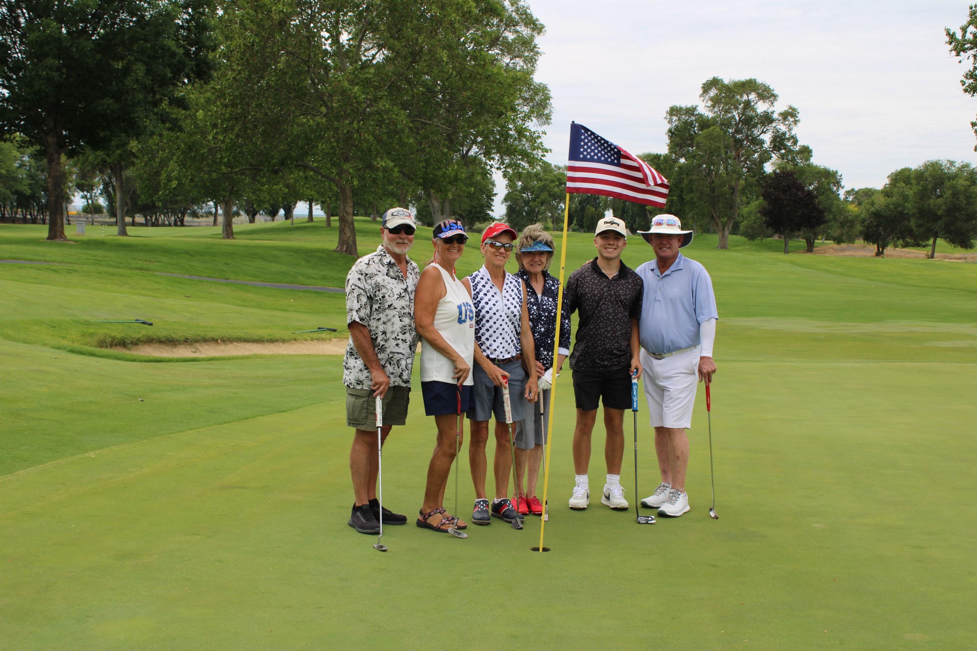 Golfers pose on the green at the Russ Hansen Memorial Scramble.