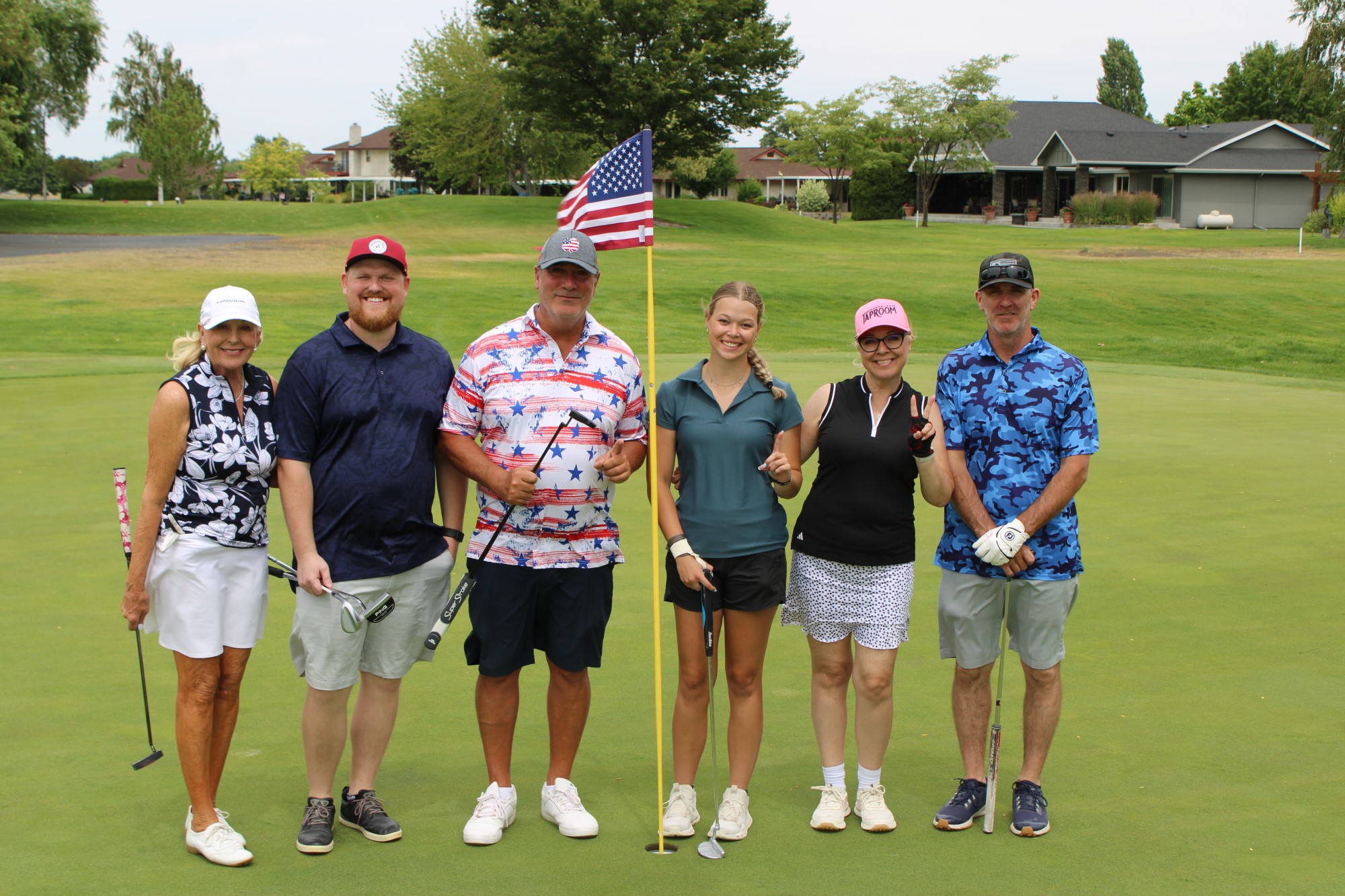 Golfers pose on the green at the Russ Hansen Memorial Scramble.