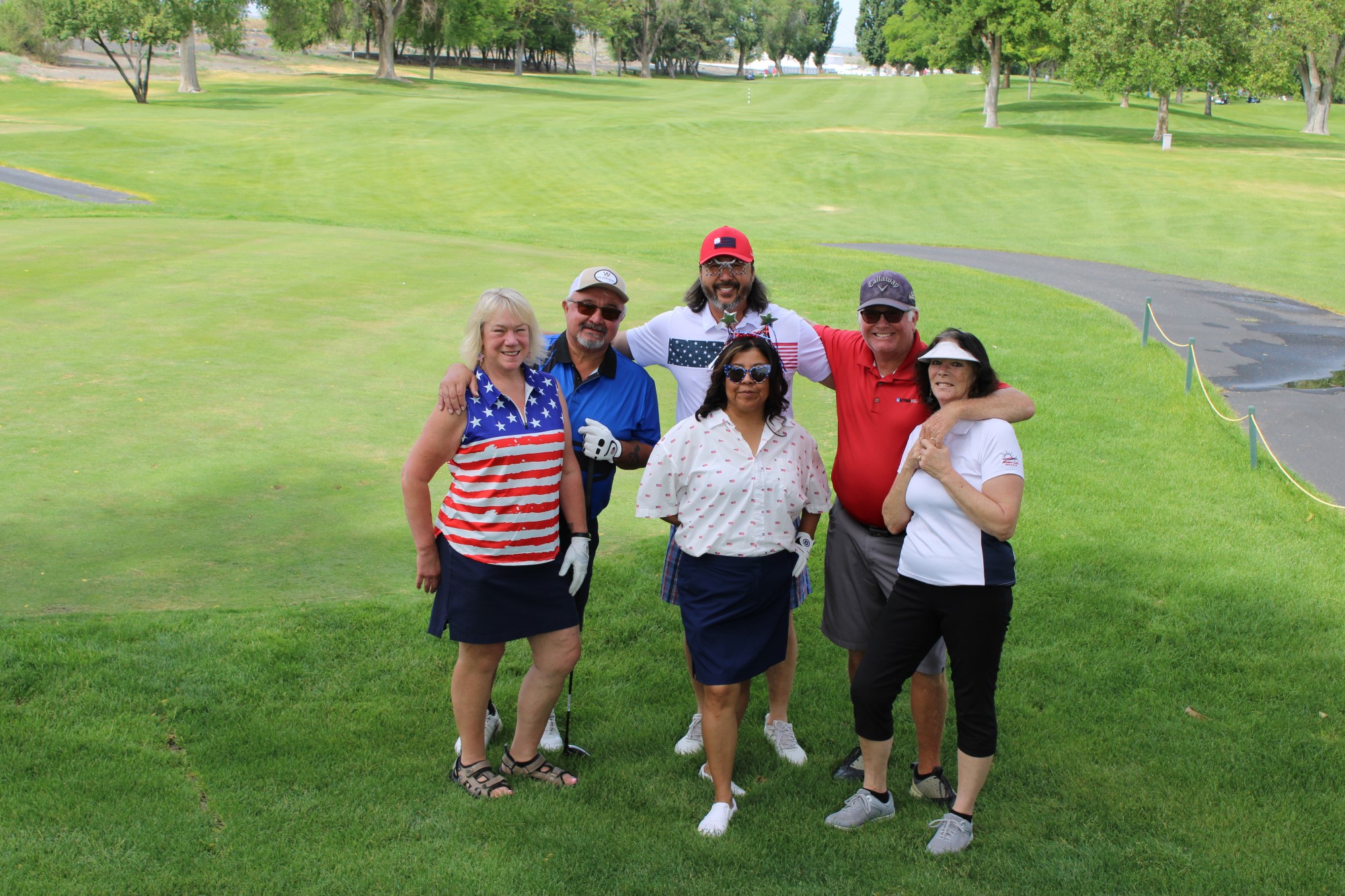 Golfers pose on the tee box at the Russ Hansen Memorial Scramble.