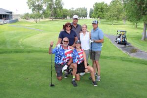 Golfers pose on the tee box at the Russ Hansen Memorial Scramble.