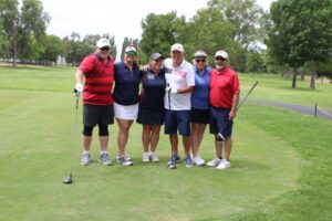 Golfers pose on the tee box at the Russ Hansen Memorial Scramble.
