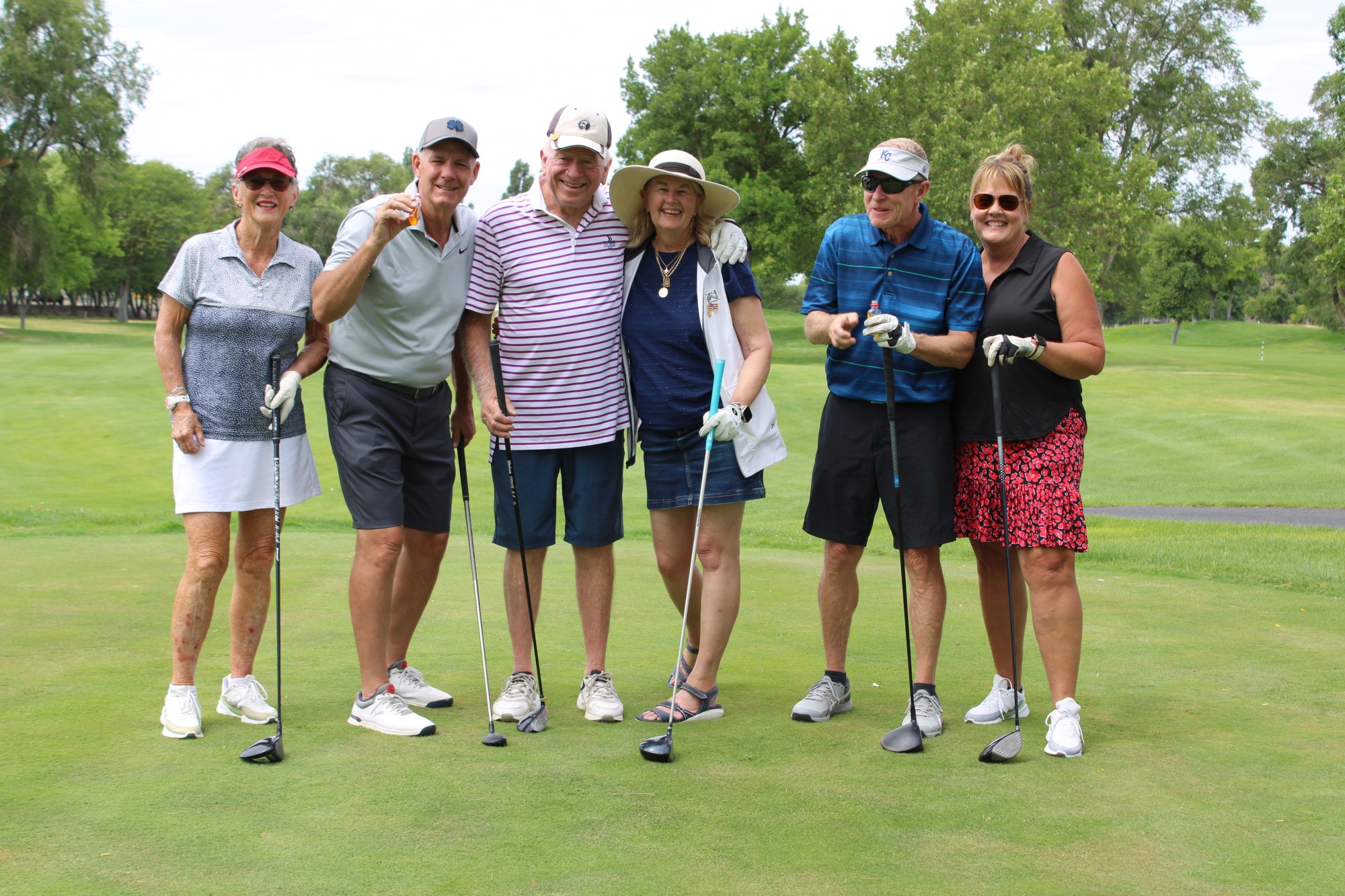 Golfers pose on the tee box at the Russ Hansen Memorial Scramble.