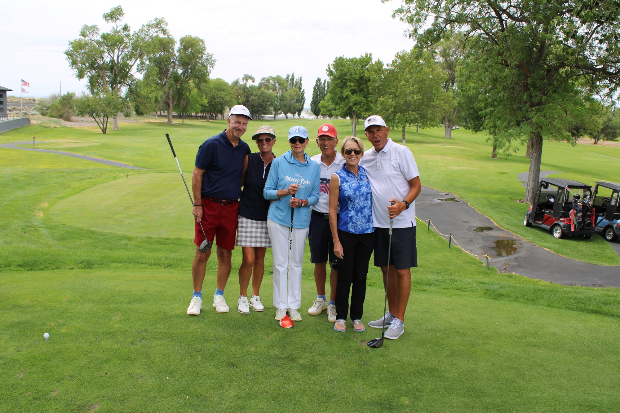 Golfers pose on the tee box at the Russ Hansen Memorial Scramble.
