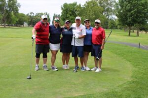 Golfers pose on the tee box at the Russ Hansen Memorial Scramble.
