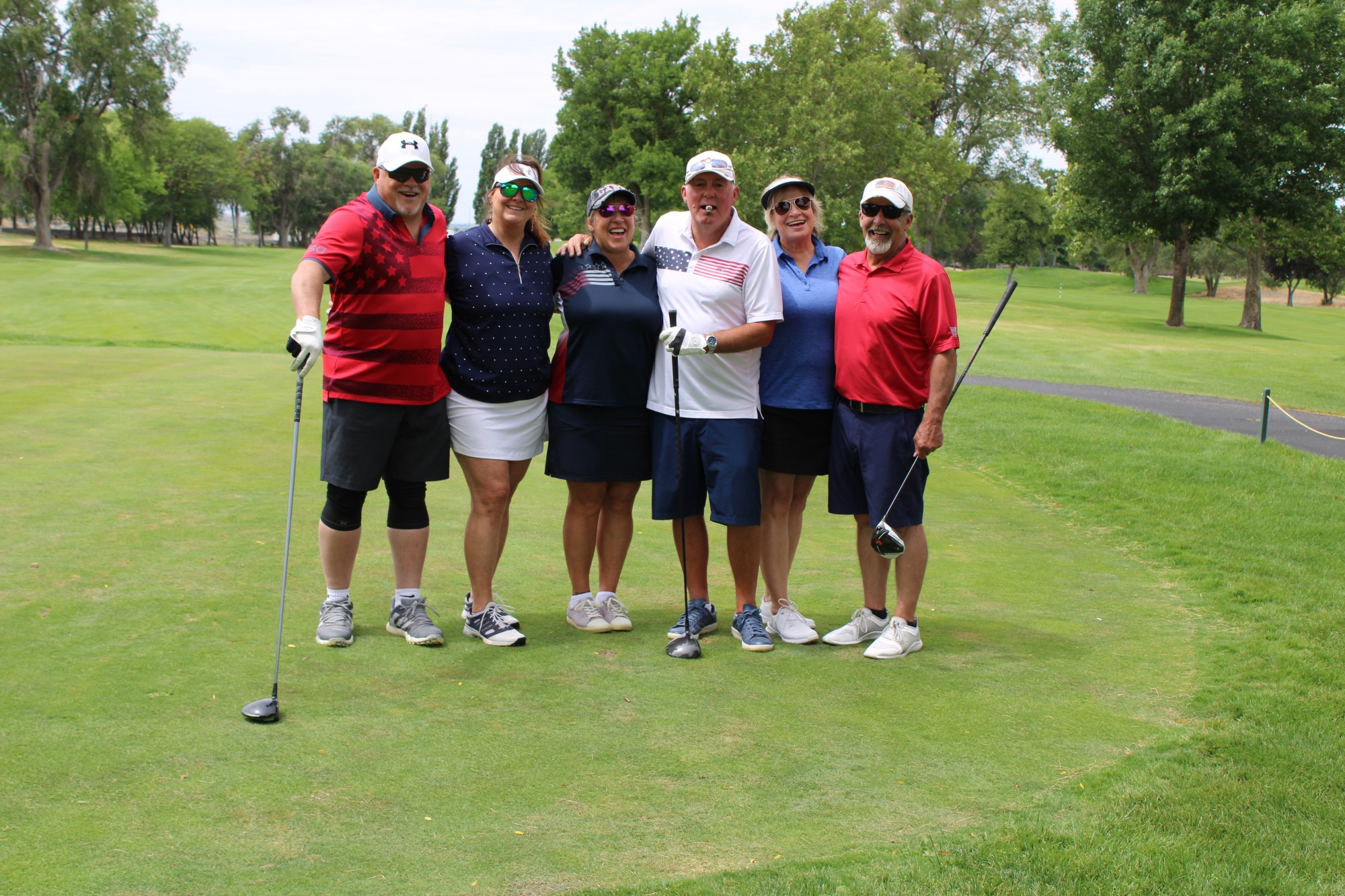 Golfers pose on the tee box at the Russ Hansen Memorial Scramble.