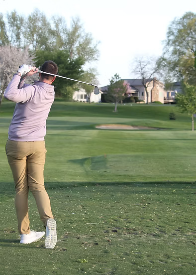Golfer in post-swing on the tee box.